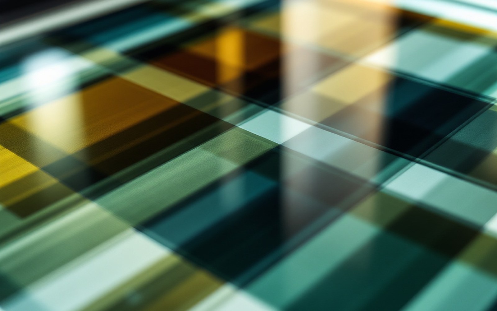 Four separate colour separation films laid overlapping on a lightbox, close